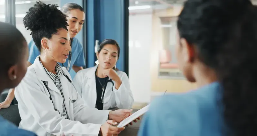 Nurse executive with DNP and medical team in background